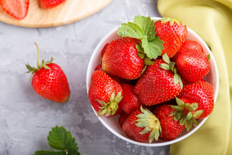 fresh red strawberry in white bowl on gray concret 2023 11 27 05 25 41 utc